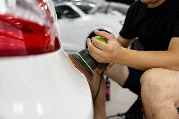 Worker buffing out car