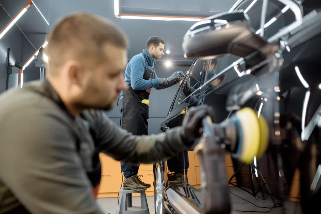 Expert collision repair specialists working on a vehicle