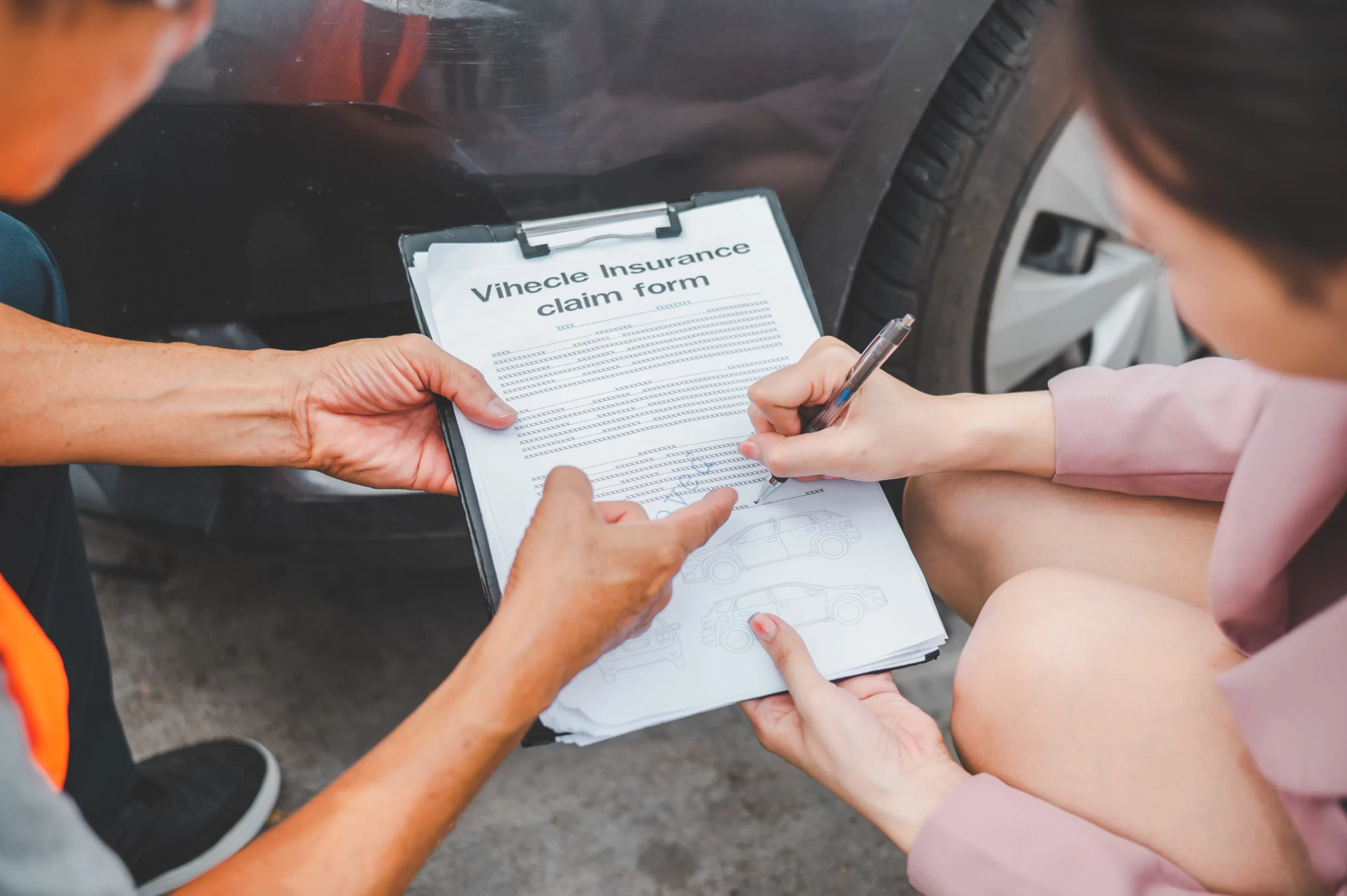 A friendly representative assisting a customer with insurance paperwork